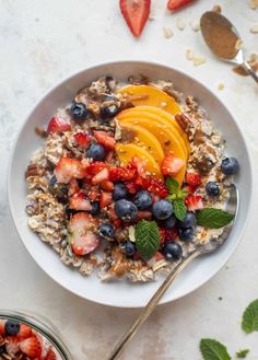 a bowl filled with oatmeal topped with fruit