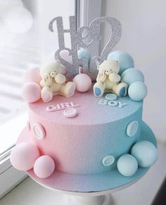 a pink and blue cake sitting on top of a window sill