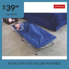 a baby laying on top of a blue cot