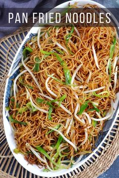 a bowl filled with noodles and vegetables on top of a table