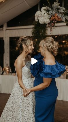 two women standing next to each other on a dance floor