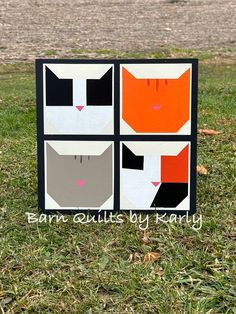 an image of cat quilts on the grass