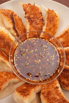 a white plate topped with fried food and dipping sauce