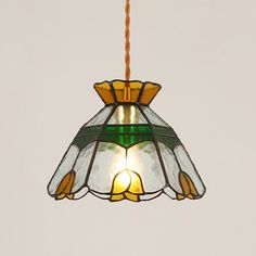 a stained glass light hanging from a ceiling