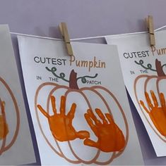 three handprints hanging from clothes pins with the words cutest pumpkin in the patch on them