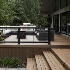 an outdoor deck with seating and plants on it