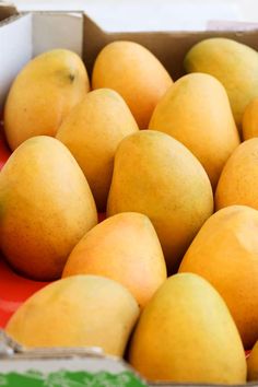 a box filled with lots of yellow pears