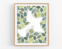 a framed print with leaves and a bird on it