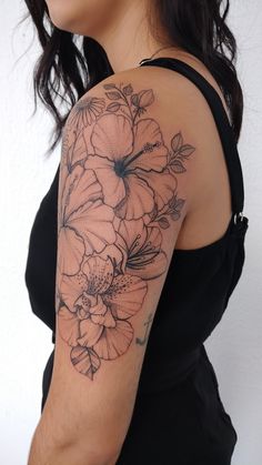 a woman's arm with flowers on it