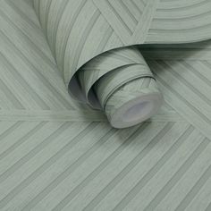 a roll of grey wallpaper with lines on it