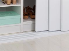 an open shoe box sitting on top of a white book shelf