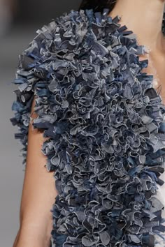 a close up of a woman's blue dress with ruffles on it