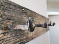 an old door handle is attached to a wooden board with metal rivets on it