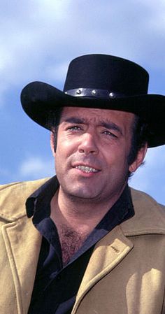 a man wearing a cowboy hat and jacket