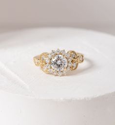 a diamond ring sitting on top of a white cake