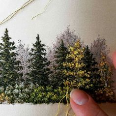 someone is stitching trees on the side of a wall