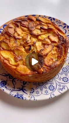 a pie sitting on top of a blue and white plate