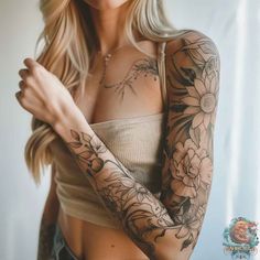 a woman with tattoos on her arms and chest is looking at the camera while holding her arm