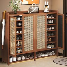 a wooden cabinet with shoes and purses on the bottom shelf in front of it