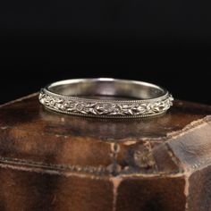 a wedding ring sitting on top of a wooden box