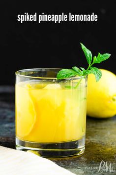 two glasses filled with lemonade sitting on top of a table