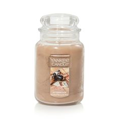 yankee candle jar with an image of a woman's hand on the front and bottom