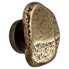 an antique brass door knob with black speckles