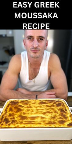 a man sitting in front of a large casserole dish with cheese on it