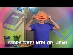 a person holding up a paper mask with the words story time with dr jean