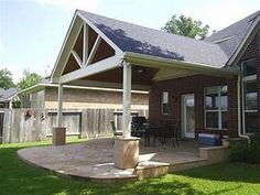 a house with a covered patio in the front yard