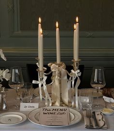 the table is set with candles and place settings