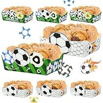 a bunch of food that is inside of a cupcake box with soccer balls on it