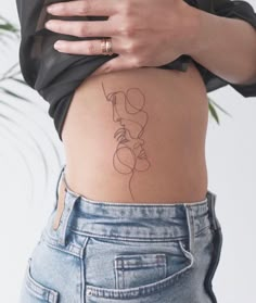 a woman with a tattoo on her stomach