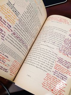 an open book sitting on top of a wooden table