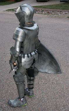 a man dressed as a knight standing in the street