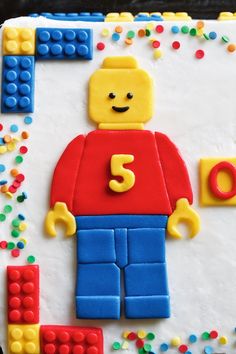 a birthday cake made to look like a lego man with the number 3 on it