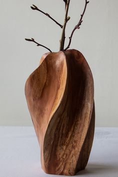 a wooden vase with some branches in it