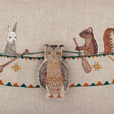 an owl is sitting on a string with other animals