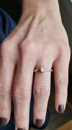 a woman's hand with a ring on it