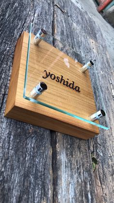 an electronic device with the word yoshida on it sitting on a wooden surface