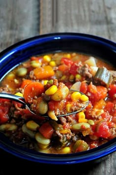 a spoon full of vegetable soup on top of a blue bowl with the title above it