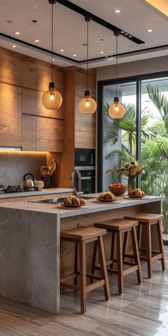 a modern kitchen with an island and bar stools