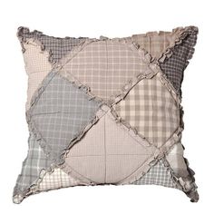 a gray and white pillow with patchwork on it