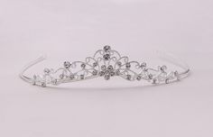 "New design! This brilliant flower girl tiara features sparkling rhinestones with a flower center perfect for the flower girl! This headpiece is perfect for the flower girl, first communion or birthday party! Measuring 1\" high, this sparkling headpiece is sure to add sparkle to your special day! All jewelry features high quality electroplating that does not fade or chip and is nickel free (hypoallergenic). Orders are shipped via USPS with tracking and confirmation. Item arrives in a complimenta Communion Tiara, Flower Girl Tiara, Girls Tiara, Crystal Tiara, Tiara Wedding, Rhinestone Tiara, Crystal Tiaras, Flower Center, Wedding Tiara