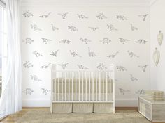 a baby's room with shark wall decals on the walls and a crib