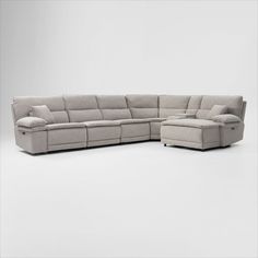 a large sectional couch with two recliners and pillows on the bottom half of it