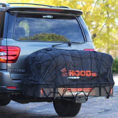 the back end of a vehicle with a black cover on it's tailgate