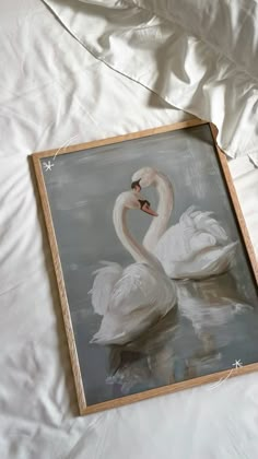 a painting of two swans on a bed