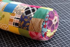 a roll of colorful fabric sitting on top of a table