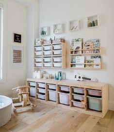 a room with wooden shelves filled with toys